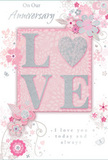 This anniversary card is a tender celebration of enduring romance, imagined here as though it rests on a polished table in a Barbican apartment, beside a vase of soft pink blooms. The colour palette fuses pastel pinks, muted mauves, and gentle silvery greys, creating a sense of treasured intimacy and calm. At the centre, the word LOVE forms the heart of the design, rendered in soft raised glitter that sparkles lightly under any light source. The letter O is replaced by a shimmering silver heart, also embossed, its textured surface inviting the touch of a curious fingertip. Around this central emblem, a halo of delicate blossoms unfurls across the card. The flowers, shaded in blush and mauve, appear almost like watercolour paintings, their edges softened and slightly blurred while still retaining defined outlines. Slender stems, swirling vines, and tiny leaves weave through the composition, their graceful curves suggesting the same care a florist might take when shaping a hand-tied bouquet for delivery around Barbican. Subtle butterflies and floating petals add light movement and a hint of whimsy, reminiscent of an English spring garden tucked between city buildings. The background is a pale, powdery pink that allows each silver and floral detail to stand out without harsh contrast. Above and below the central design, the phrases On Our Anniversary and I love you today and always appear in a refined script, the letters slim yet clear, echoing the card's gentle tone. Altogether, the composition feels like a quiet, beautifully arranged tribute to shared years and heartfelt promises in the heart of the city.